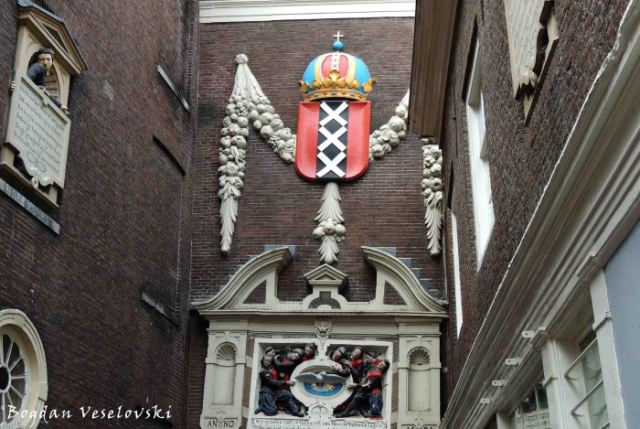 19. Amsterdam Museum's entrance - Coat of arms of Amsterdam & Relief with orphan children grouped around the emblem of the Amsterdam civic orphanage, the Burgerweeshuis on Kalverstraat, circa 1581 by Joost Jansz Bilhame
